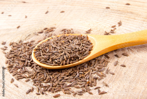 Cumin in a spoon . Close Up .