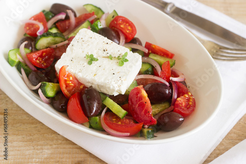Traditional greek salad with fresh vegetables, feta cheese and olives.