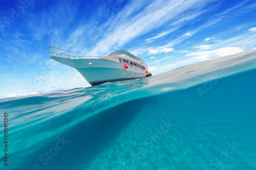Small safari boat with beautiful split shot under and above water. © Jag_cz