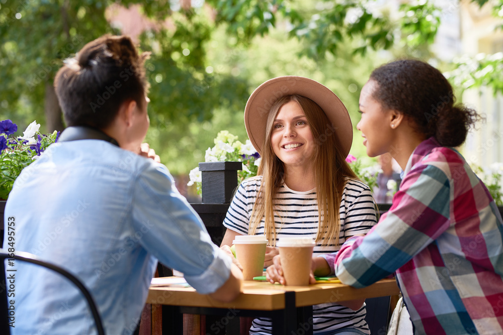 Students Chatting at Lunch in Cafe Outdoors Students Chatting at Lunch in Cafe Outdoors