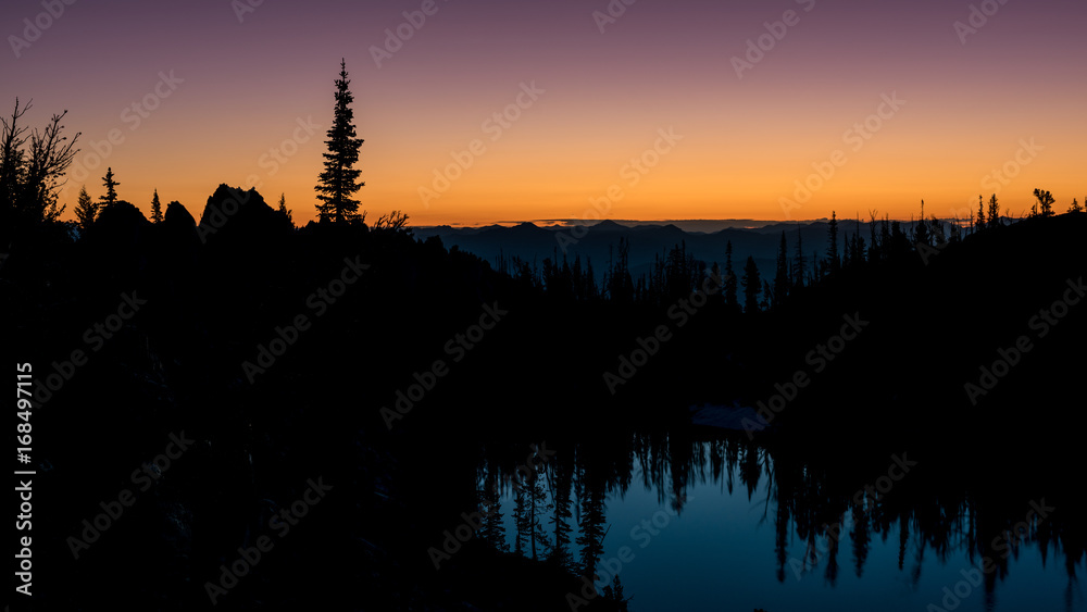 First light of morning creating a silhouette over the mountains of Idaho
