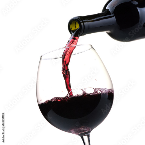 Pouring red wine into a wineglass photo