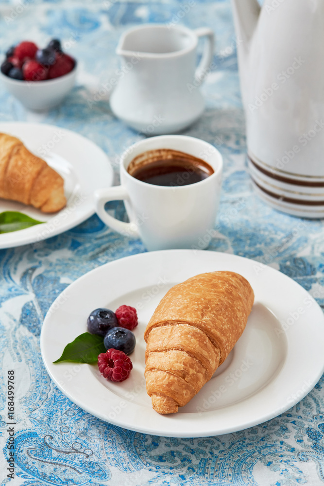 Fresh berries, coffee and croissant.Morning breakfast