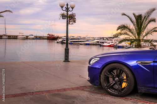 Sport car on the sand beach. Expensive, luxury car near the sea