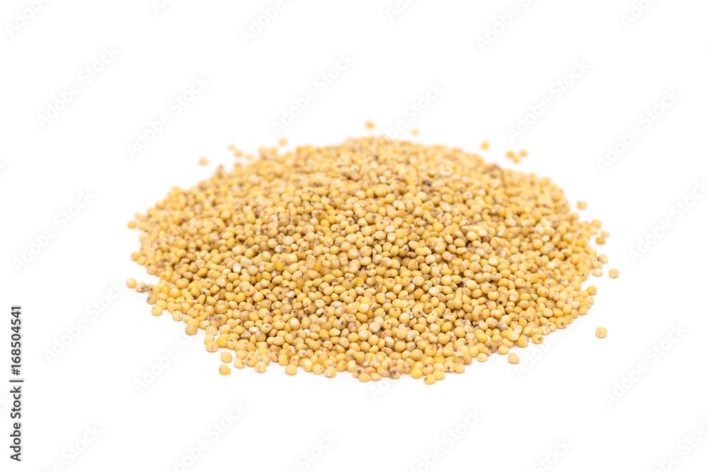 Heap of organic millet groats, sideview, isolated Heap of organic millet groats, sideview, isolated