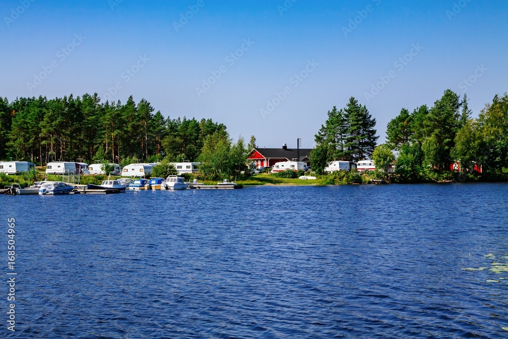 Camping life with caravans in nature park by the lake Camping life with caravans in nature park by the lake