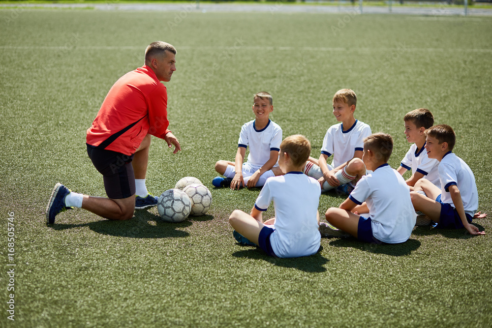 Naklejka premium Coach Instructing Junior Football Team