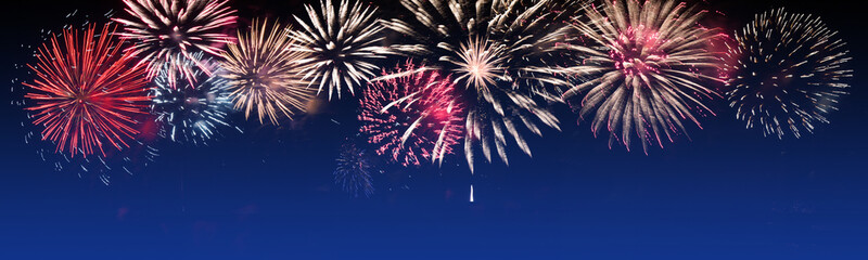 Brightly Colorful Fireworks on twilight background - party celebration concept