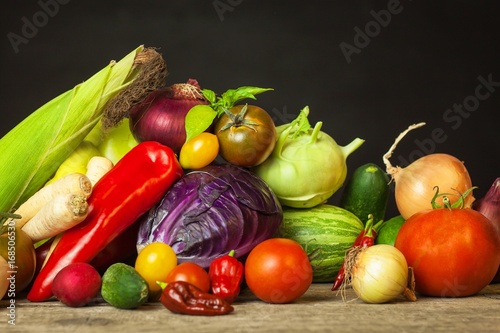 Different types of fresh vegetables on a wooden table. Harvesting vegetables on a farm. Healthy food.