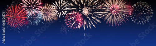 Canvas Print Brightly Colorful Fireworks on twilight background - party celebration concept