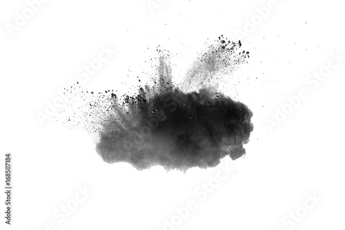 Black powder explosion. Closeup of black dust particles explode isolated on white background.