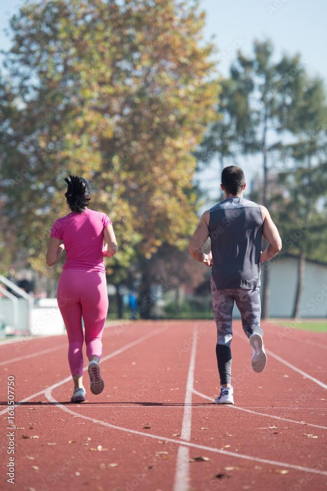 Athlete Couple Sprinting on the Running Track
