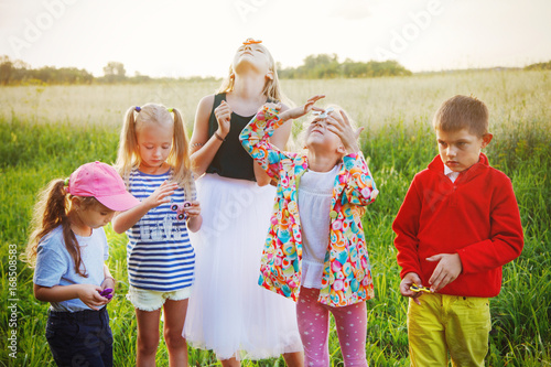 A group of children play by the spinners photo