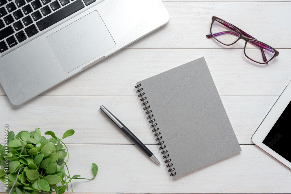 Notepad, laptop, pen on white table, Office concept. Notepad, laptop, pen on white table, Office concept.
