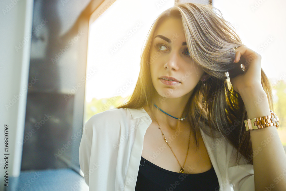 Modern business woman in the office with copy space. Woman standing near window and looking forward. Modern business woman in the office with copy space. Woman standing near window and looking forward.