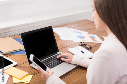 Business woman using phone with blank screen