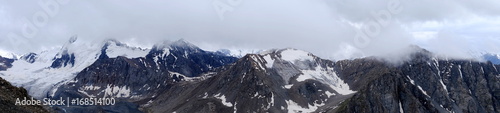 Panorama of mountain peaks in the clouds © Qzian