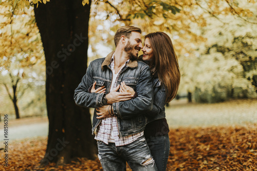 Smiling couple hugging in a...