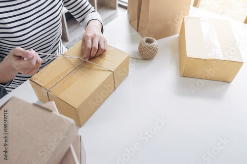 Internet online shopping concept, Young seller woman preparing package to be sent Mail transportation, service network connection market, technology on global, Order online for customer convenience