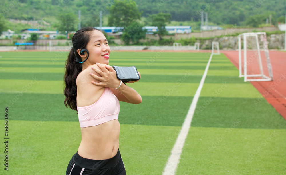 Girl stretching with modern jogging equipment for Girl stretching with modern jogging equipment for