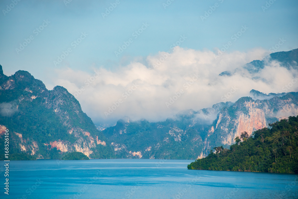 Paradise landscape at Ratchaprapa dam, Khao Sok, Surat Thani, Thailand. Beautiful lake, mountain and bright blue sky background. Irrigation watercontrol concept.