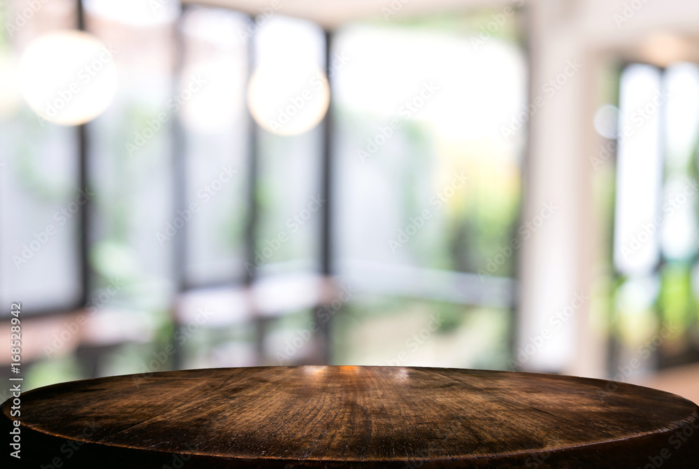 Image of Selected focus empty wooden table and Coffee shop or blurred cafe background of abstract with bokeh image. for montage or display your products