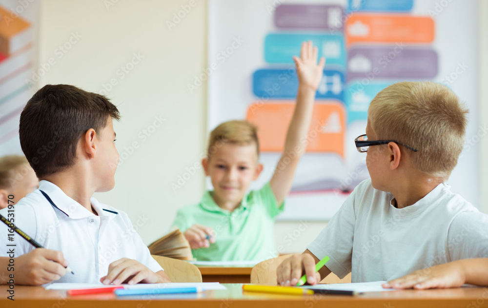 Portrait of schoolboy raises his hand at the lesson Portrait of schoolboy raises his hand at the lesson