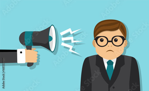 Sad tired businessman stands, and someone scolds a businessman in a megaphone