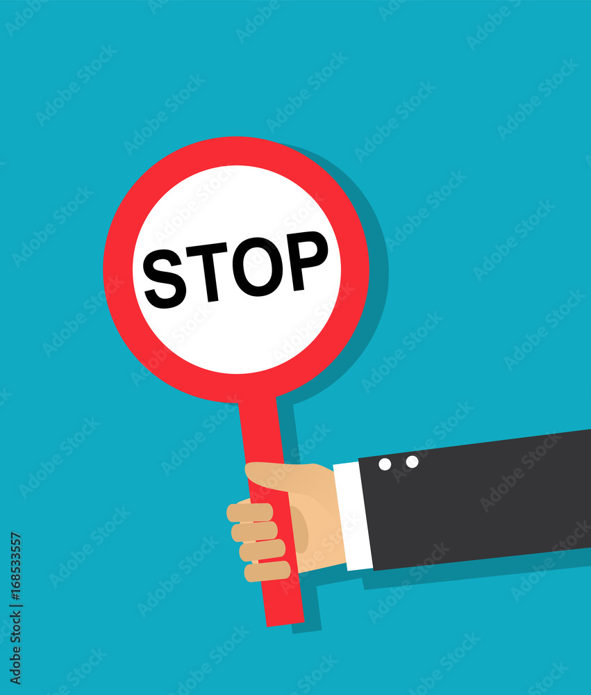Human hand holds a red round stop sign Human hand holds a red round stop sign
