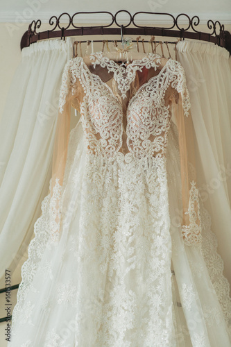 Wedding dress hanging in bridal suite © agaltsov
