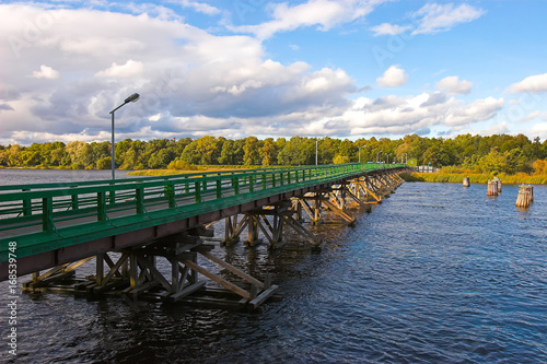 Fototapeta Naklejka Na Ścianę i Meble -  Wooden bridge. Bridge on wooden supports.