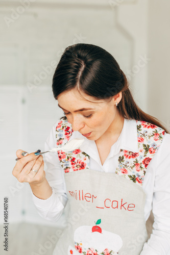 Young girl making cream for cupcakes.