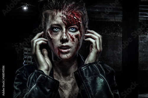 Close-up portrait of horrible zombie woman with wounds. Horror. Halloween poster. photo