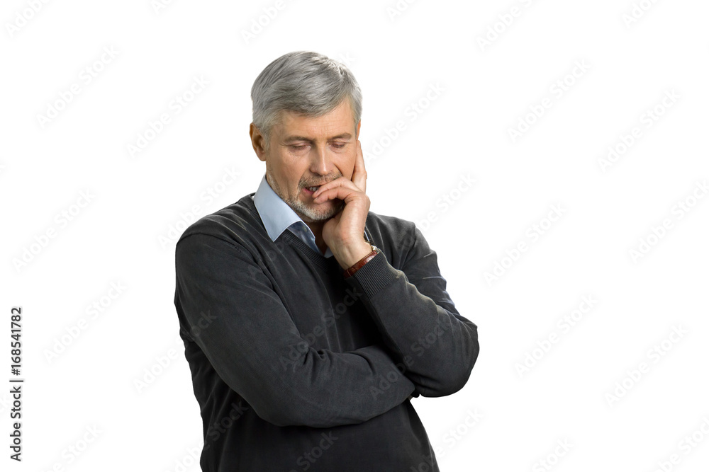 Mature man lost in deep thoughts. Depressed senior man thinking against white background. Feelings of negative emotions and sadness. Mature man lost in deep thoughts. Depressed senior man thinking against white background. Feelings of negative emotions and sadness.