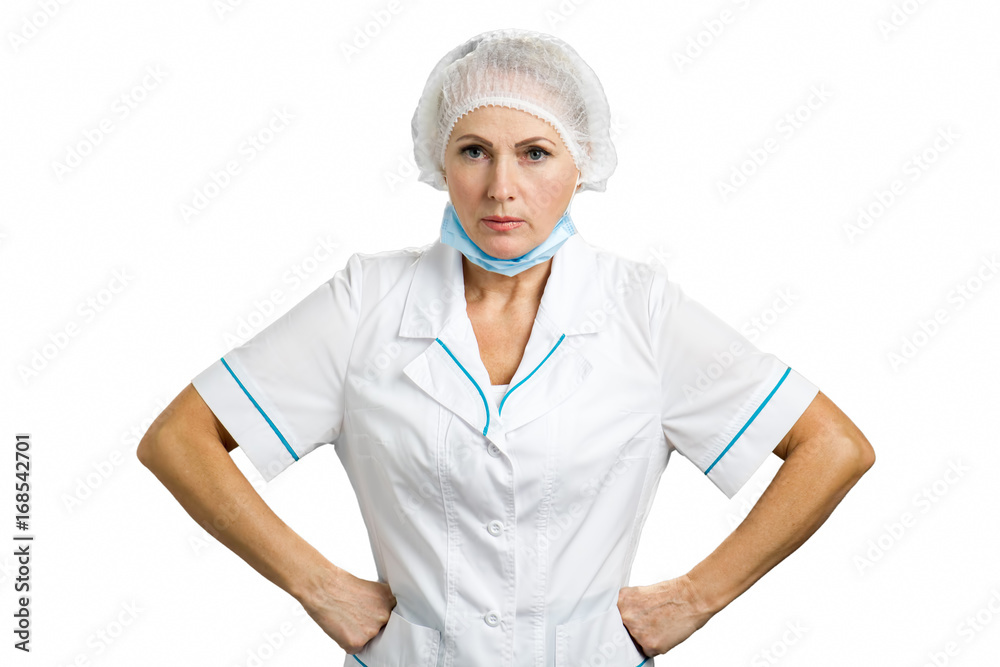 Serious female mature doctor. Portrait of angry female doctor isolated on white background. Severe mature female doctor keeping hands on hips and giving instructions. Serious female mature doctor. Portrait of angry female doctor isolated on white background. Severe mature female doctor keeping hands on hips and giving instructions.