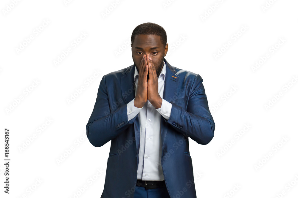 Frustrated young businessman with clasped hands. Man in formalwear holding hands clasped near mouth. In searching of solution. Frustrated young businessman with clasped hands. Man in formalwear holding hands clasped near mouth. In searching of solution.
