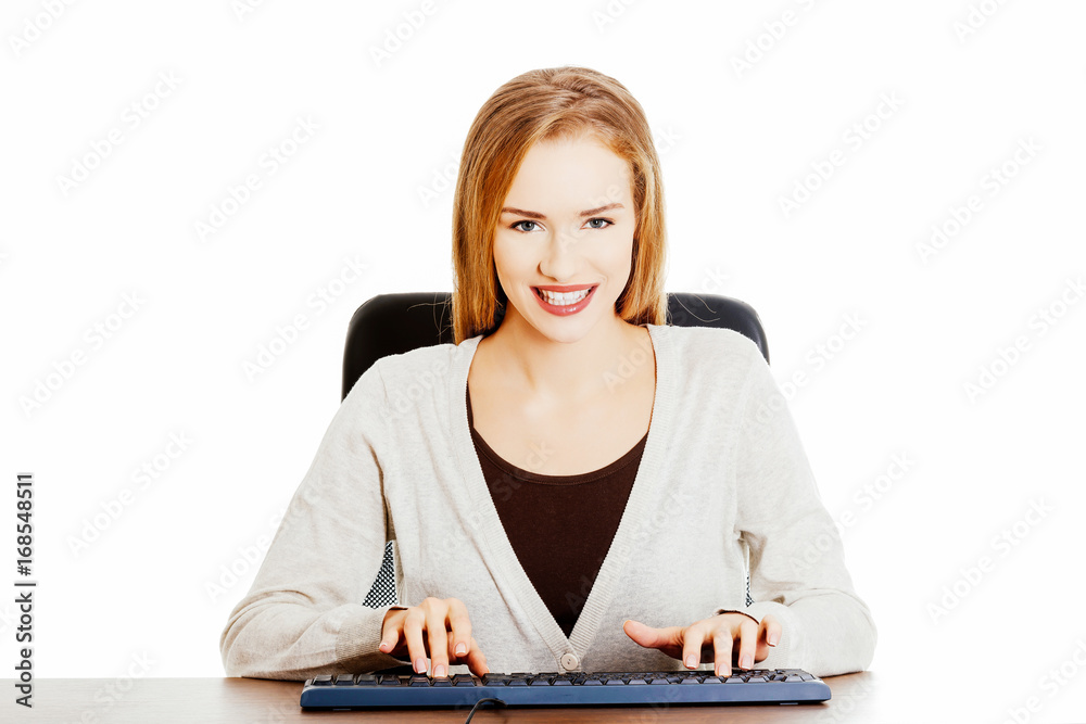 Beautiful casual woman student is writing on keyboard. Beautiful casual woman student is writing on keyboard.