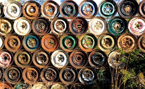 Industrial Urban Rusty Wheels Hubcaps Fence photo