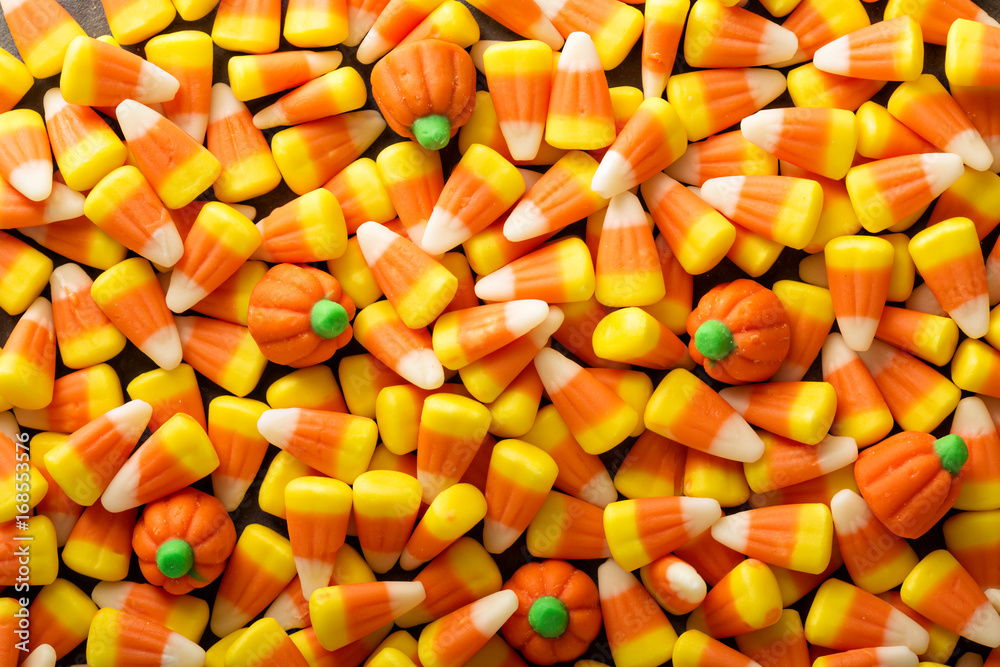 Candy corn and pumpkin Halloween background Candy corn and pumpkin Halloween background