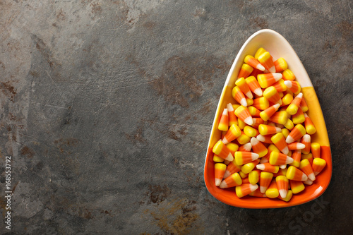 Candy corn in a bowl Halloween background photo