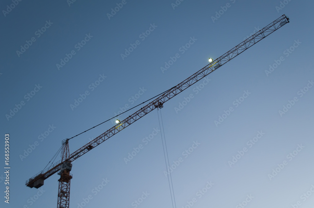 Tower crane against the sky, jib crane, view from below Tower crane against the sky, jib crane, view from below