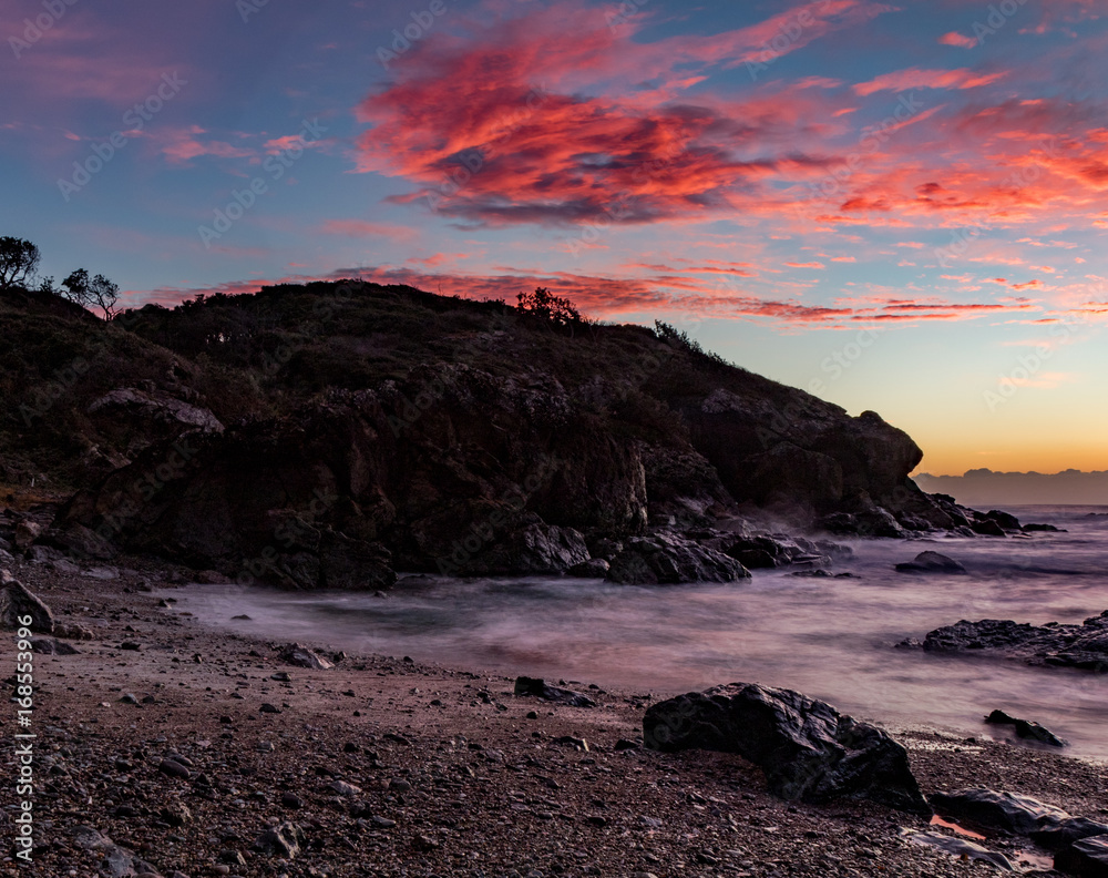 Fototapeta premium Red clouds over the headland