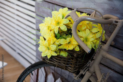 Close-up of yellow flowers in a basket on a bicycle