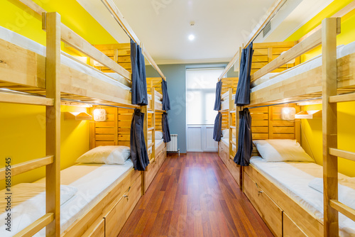 Hostel dormitory beds arranged in room photo
