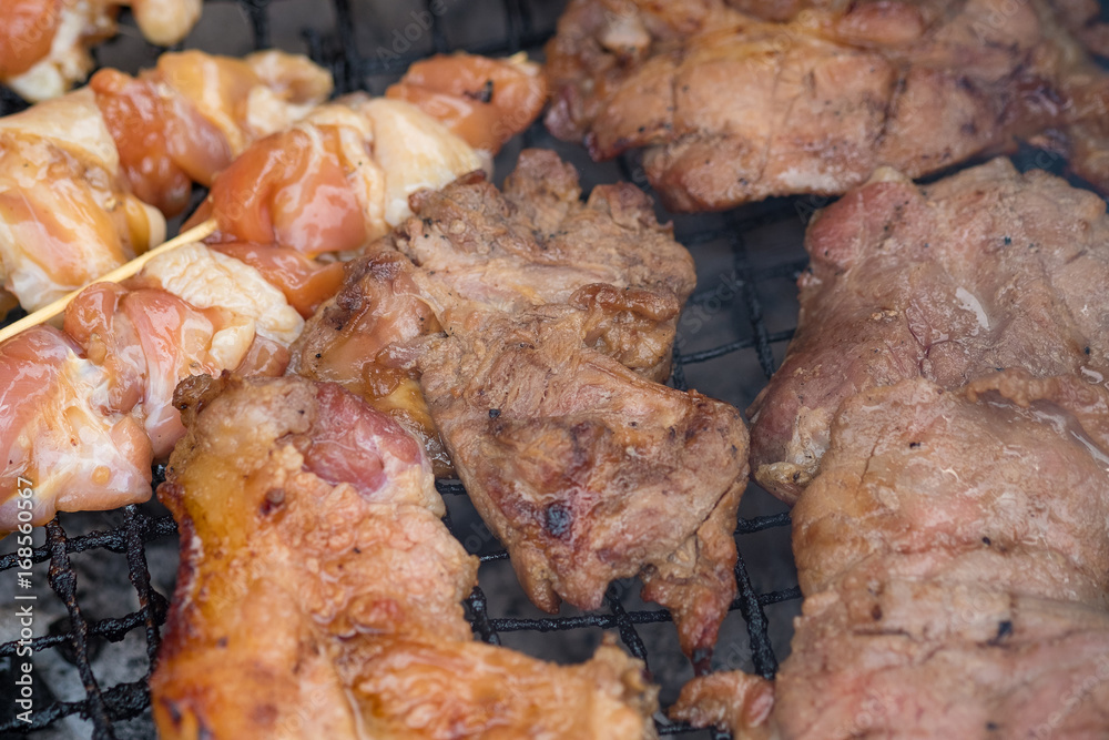 Chicken and pork grill over the small flame. shallow DOF. Chicken and pork grill over the small flame. shallow DOF.