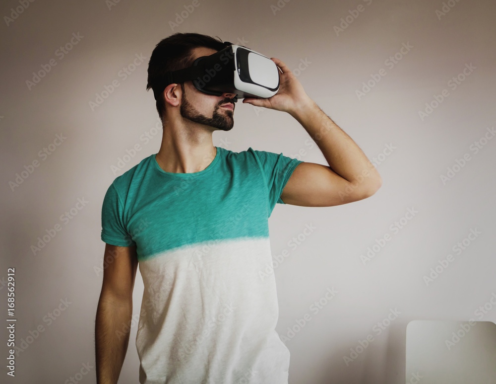 Young bearded man wearing virtual reality. Young bearded man wearing virtual reality.
