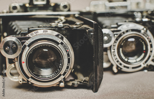 Old vintage retro camera still life on fabric background close up