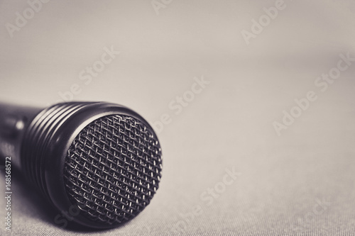 Microphone on fabric background with copy space close up