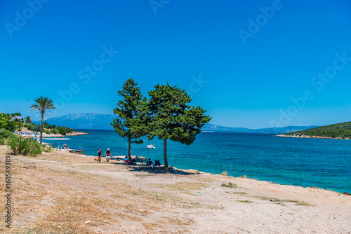 Cesme, Turkey - July 07, 2017 : People swimming and sunbathing at Sifne Beach