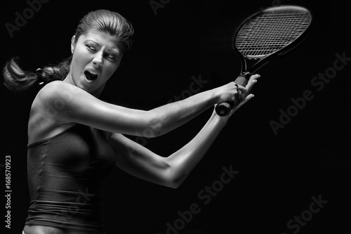 Ready to hit / A portrait of a tennis player with a racket. © Fisher Photostudio
